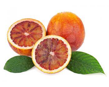 Ripe red blood oranges with cut and green leaves isolated on white background. Closeup.
