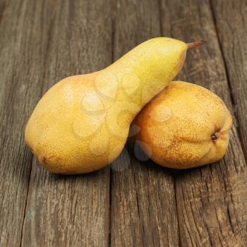 Ripe pears on wooden background. Closeup.