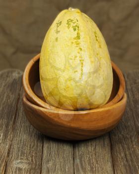 Big marrow squash  in bowl on wooden background. Closeup.