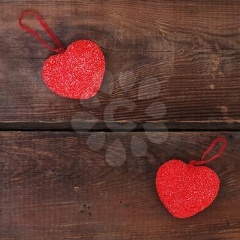 Red hearts on wooden background. Closeup.