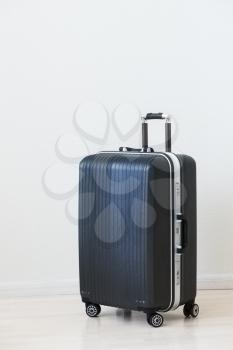 Large family polycarbonate luggage on white wooden background. 