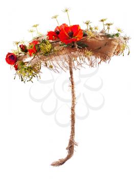 Decorative umbrella of burlap, mats and artificial poppy flowers isolated on white background.
