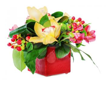 Colorful floral bouquet of roses, cloves and orchids arrangement centerpiece in vase isolated on white background.