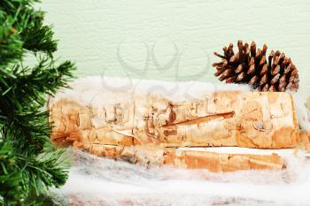 Abstract Cristmas composition from fir branches and birch logs.