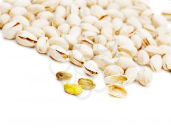Dry salted pistachios on white background. Closeup.