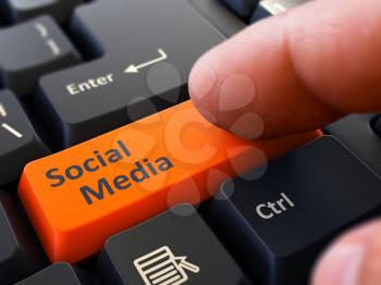 Social Media Button. Male Finger Clicks on Orange Button on Black Keyboard. Closeup View. Blurred Background. 3D Render.