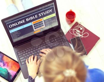 Online Bible Study. Young Woman Writes a Text on Modern Portable Ultrabook Keyboard with Open Educational Web Site While Having Recreation Time at Home. Continuing Education Concept.