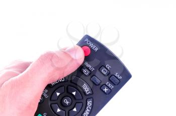 Hand holding a TV control isolated on a white background