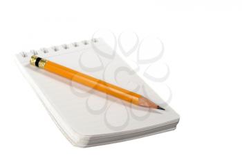 Yellow pencil and notepad isolated on white
