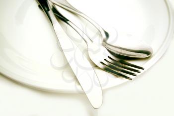  Macro shot of silverware over a white plate