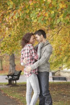 Romantic Teenage Couple In Autumn Park