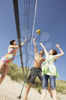 Group Of Teenage Friends Playing Volleyball On Beach