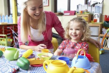 Young woman playing with girl