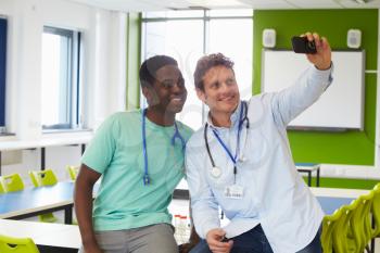 Student And Tutor Studying Medicine Taking Selfie