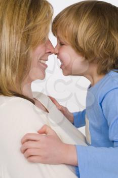 A mother and son nose to nose and laughing