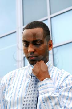 Portrait of a young attractive businessman next to a corporate building