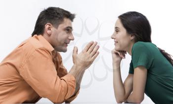 Happy couple having conversation face to face and looking at each other