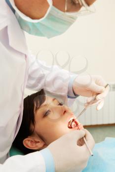 A dentist examining a girls teeth