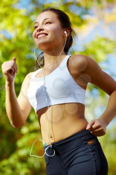 Portrait of a young woman jogging with a player