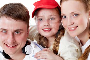 Portrait of happy parents and their daughter looking at camera