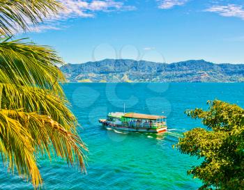 Boat on Lake Toba in Sumatra, Indonesia. It is the largest and deepest volcanic crater lake in the world.