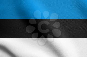 Flag of Estonia waving in the wind with detailed fabric texture. Estonian national flag.