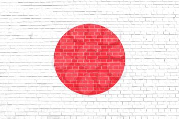 Flag of Japan on brick wall texture background. Japanese national flag.
