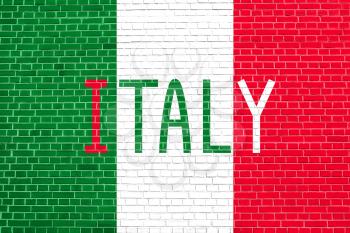 Flag of Italy on brick wall texture background. Italian national flag. Word Italy.