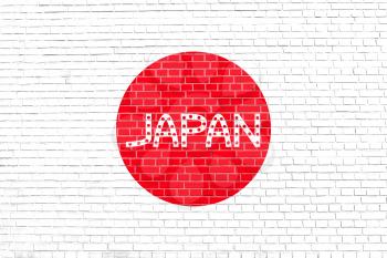 Flag of Japan on brick wall texture background. Japanese national flag. Word Japan.