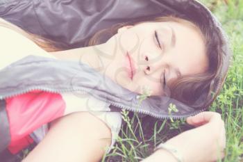 young beautiful girl sleeping and green grass