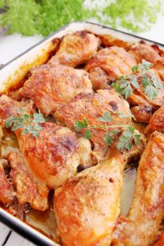 Baked chicken drumsticks on a baking tray 