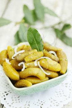 Pickled  gherkin with onion and bay leaf