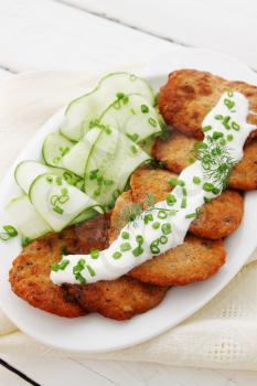 Pancakes from caviar carp with sour cream and cucumber