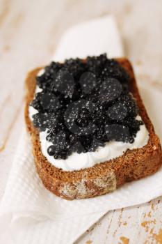 slice of bread with sour cream and caviar