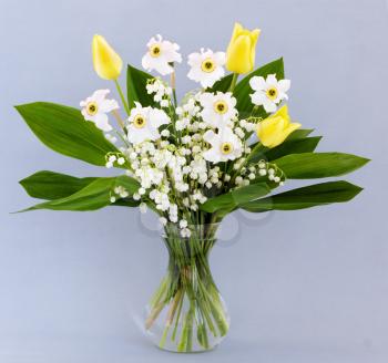 Spring bouquet of tulips, daffodils and lilies of the valley