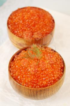 Red Red caviar in a large wooden bowl
