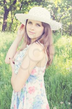 Young woman in a hat at the park