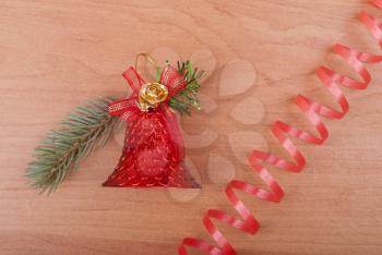 Christmas toy and serpentine on the wooden background.