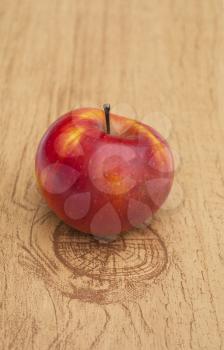 Red ripe apple on a wooden table