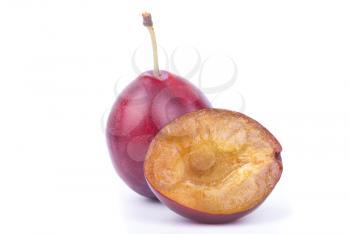 Whole and sliced ​​plums isolated on a white background.