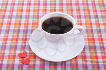 Cup of coffee and two hearts.