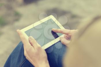 Man with tablet in hand on the street.