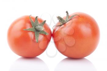 Two red tomatoes isolated on a white background.