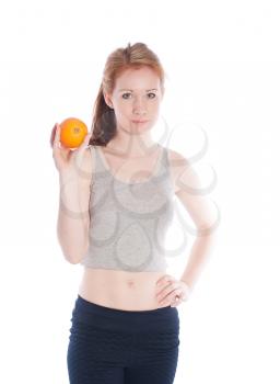 Athletic girl with orange in hands on a white background.