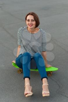 Attractive girl with a skateboard.