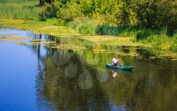 Old Man Fishing Out Of A Row Boat