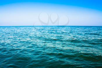 Calm sea ocean and blue clear sky background texture view