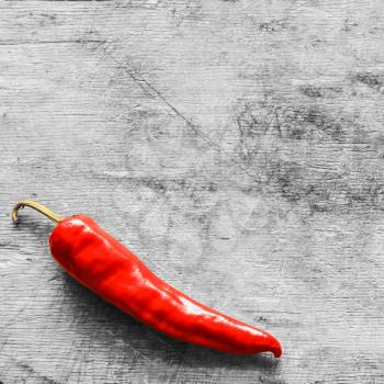 Red Hot Chili Pepper On Old Gray Wooden Table Surface Texture Background