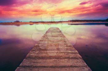 Old Wooden Pier. Calm River Nature Background. Toned Instant Filtered Photo Image