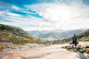 Young Man Goes On A Mountain Hiking Trail In The Mountains Of Norway. Landscape Of Norwegian Mountains. Nature Of Norway. Travel And Hiking. Amazing Scenic View At Sunny Summer Day. Nobody. Scandinavia. Blue Sky